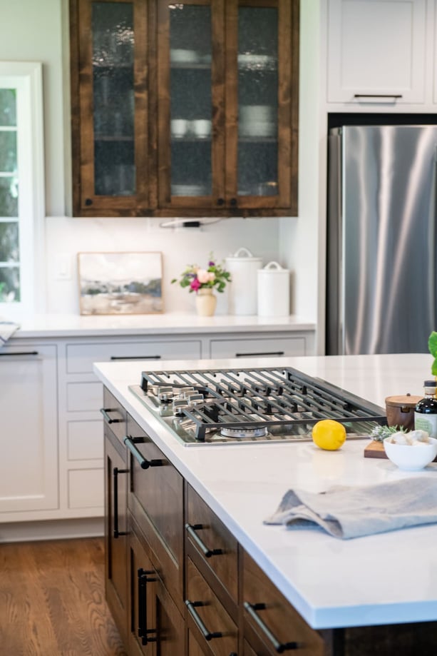 kitchen island with stovetop and brown cabinets in remodeled kitchen in Corvallis, Oregon by Corvallis Custom Kitchen & Baths kitchen island with stovetop and brown cabinets in remodeled kitchen in Corvallis, Oregon by Corvallis Custom Kitchen & Baths