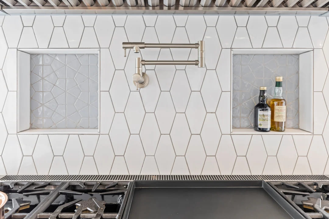 Lebanon kitchen remodel showing detailed speciality tile backsplash behind built-in range Lebanon kitchen remodel showing detailed speciality tile backsplash behind built-in range